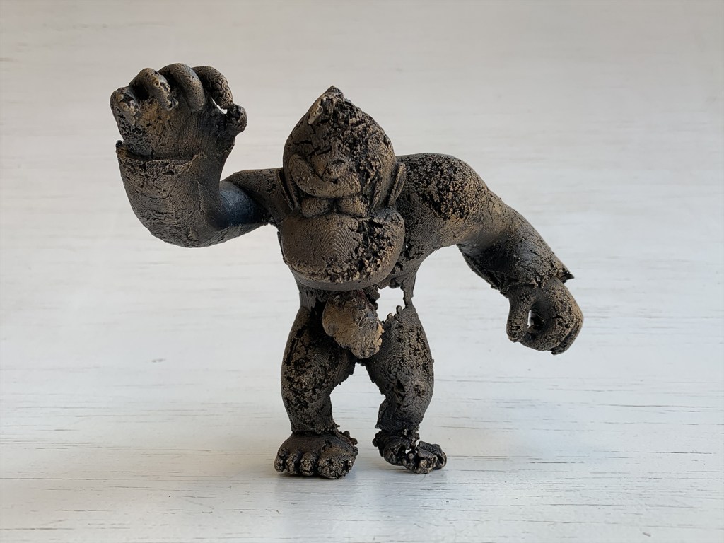 front view - a bronze sculpture of a gorilla-like character